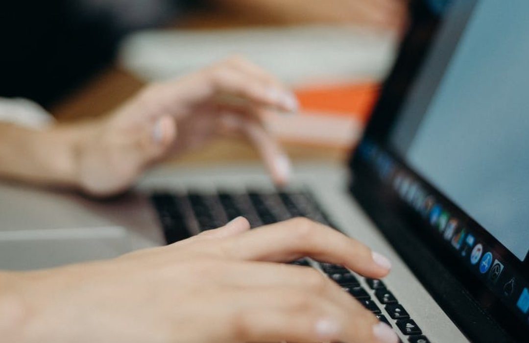 a person typing on a laptop