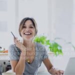 Home 8 a woman smiling at a laptop