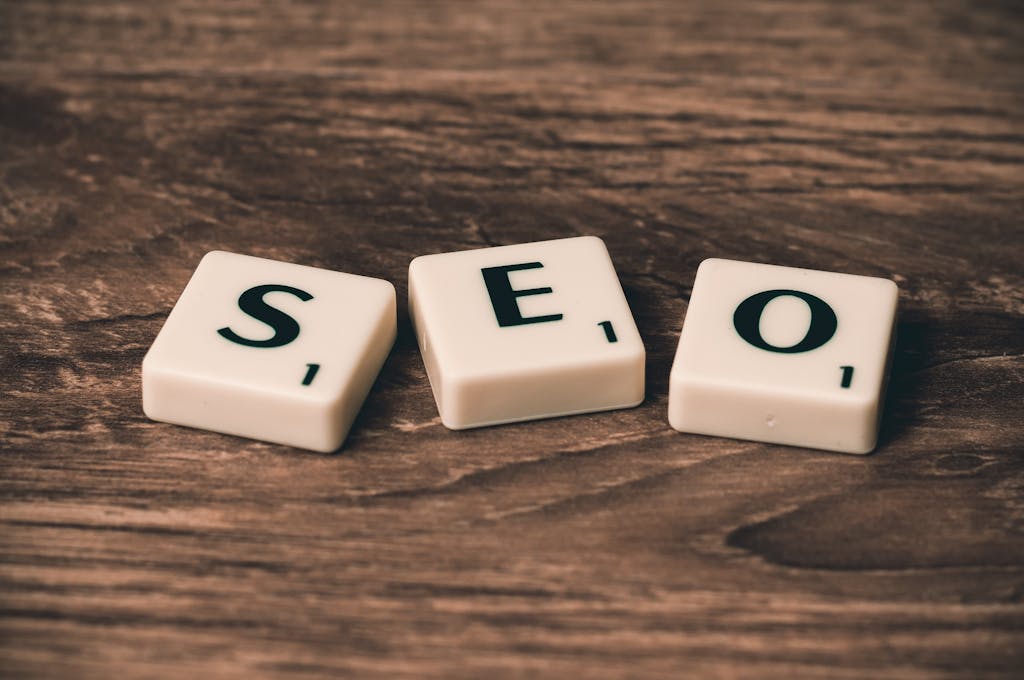 Topics 3 Scrabble tiles spelling 'SEO' on a wooden surface. Ideal for digital marketing themes.